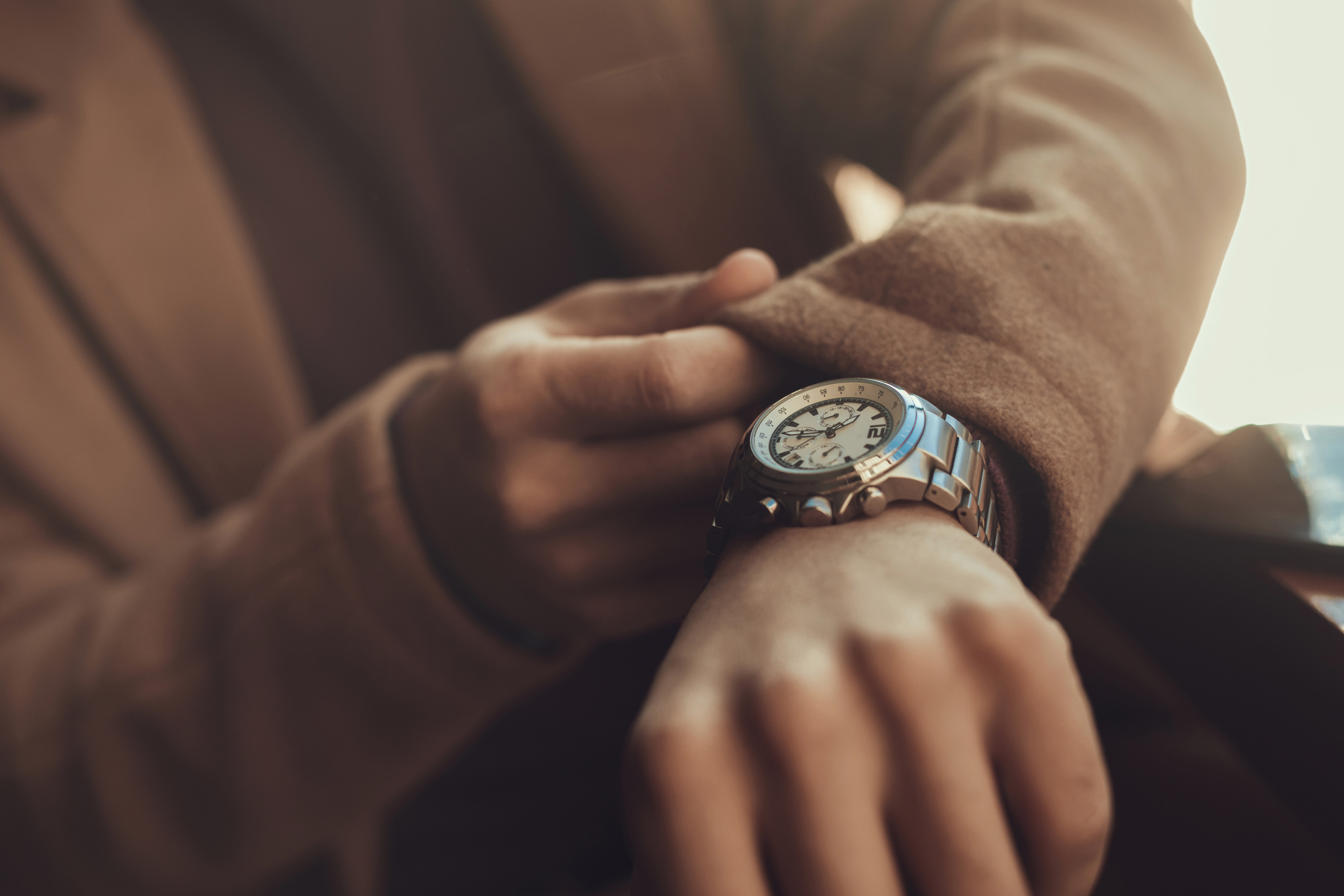 Man wearing stylish silver wristwatch